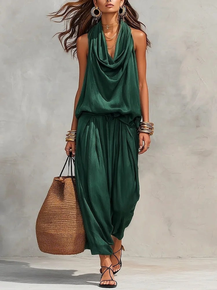 Woman wearing the Simona Two-Piece Top & Pants Set in green, accessorized with a handbag and jewelry.
