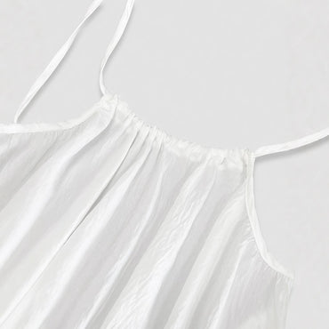Elegant Backless Maxi Evening Dress close-up of white fabric and straps for a stylish look