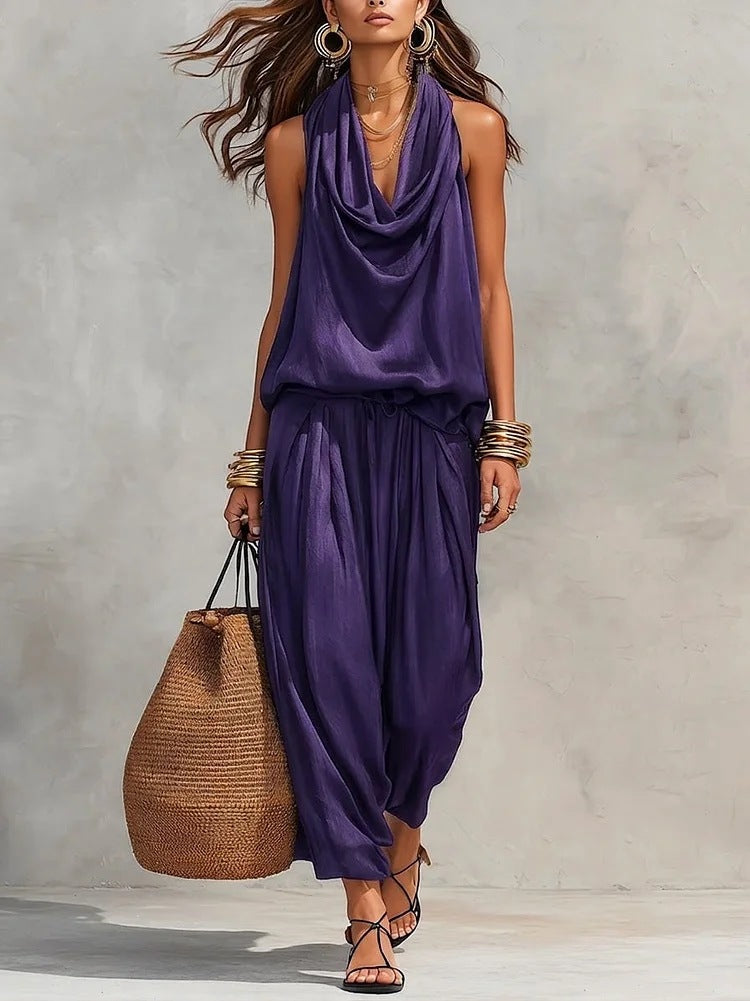 Woman wearing Simona Two-Piece Top & Pants Set in purple, styled for casual outings with a stylish handbag.