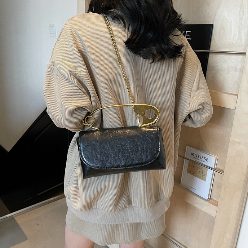 Luxury PU Leather Chain Shoulder Bag for Women worn by a woman, showcasing its elegant design and stylish functionality.