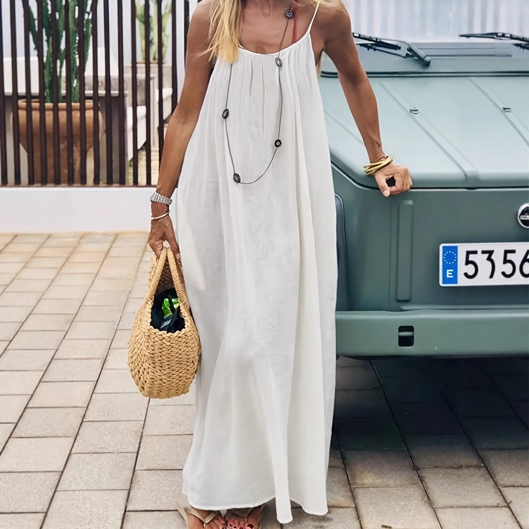 Elegant Backless Maxi Evening Dress worn outdoors with a stylish straw bag, showcasing an elegant summer look.