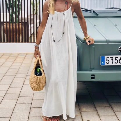 Elegant Backless Maxi Evening Dress worn outdoors with a stylish straw bag, showcasing an elegant summer look.