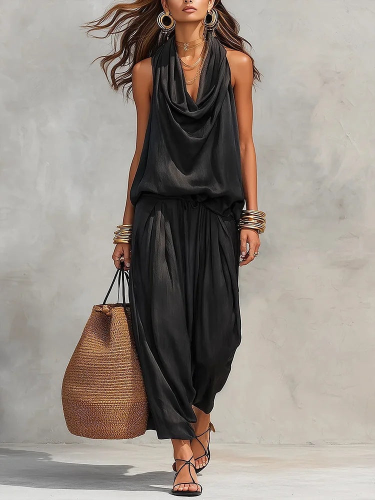 Model wearing the Simona Two-Piece Top & Pants Set, styled with accessories and a bag, showcasing a chic look.