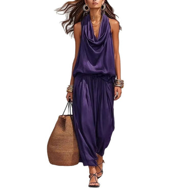 Woman wearing Simona Two-Piece Top & Pants Set in purple, carrying a large woven bag, showcasing stylish comfort.