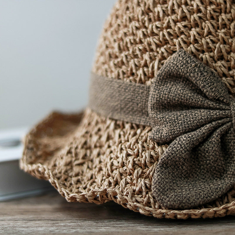 Vintage Foldable Straw Sun Hat with Wide Brim Bow featuring a stylish bow and natural straw design.