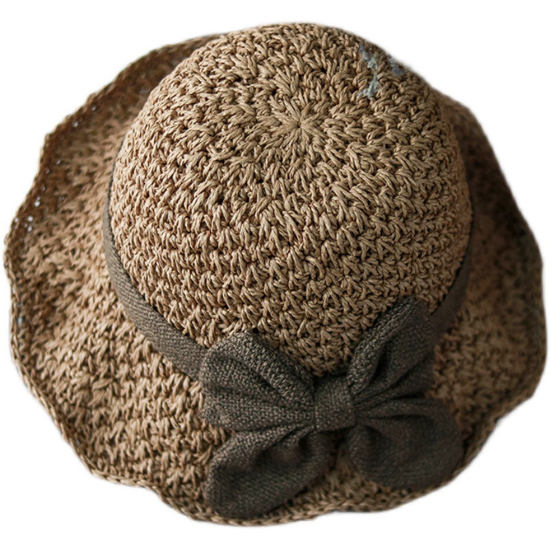Vintage Foldable Straw Sun Hat with Wide Brim Bow, stylish outdoor accessory perfect for summer. Elegant design with brown bow.