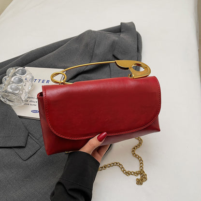 Luxury PU Leather Chain Shoulder Bag for Women in red with gold accents, styled with a gray blazer.