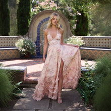 Vera Elegant Dress for Stylish Party & Casual Wear showcasing floral print and lace-up design in a garden setting.