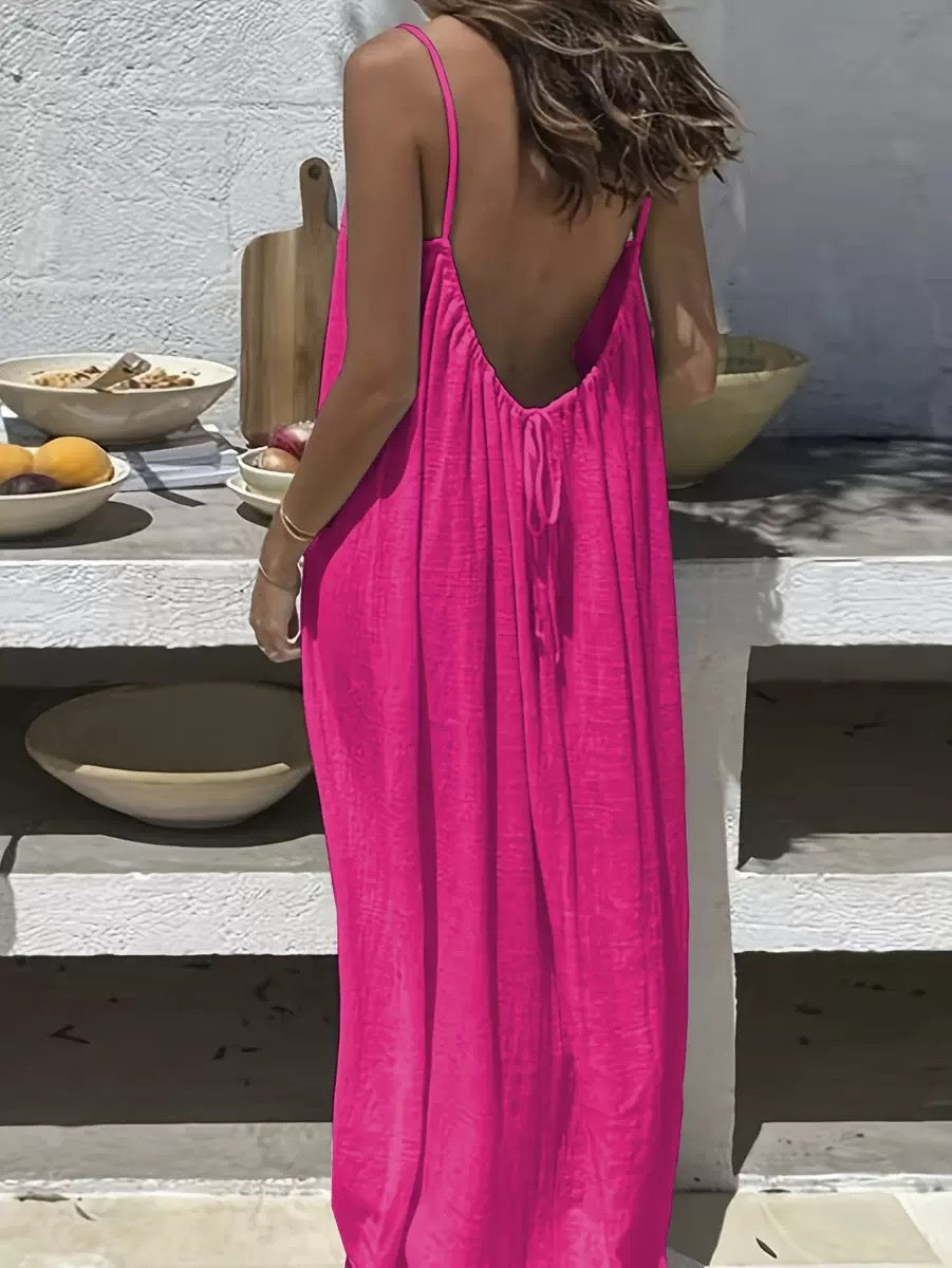 Woman wearing an Elegant Backless Maxi Evening Dress in vibrant pink, showcasing a stunning back view.
