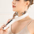 Woman using a Facial Massager for Face and Neck to enhance her skincare routine with soothing effects.