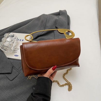 Luxury PU Leather Chain Shoulder Bag for Women with a stylish gold chain handle on a gray background.