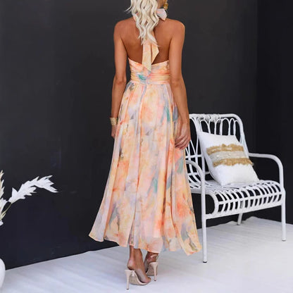 Elegant Flower Print Sleeveless Dress in pastel colors with open back and flowing skirt, perfect for summer occasions.