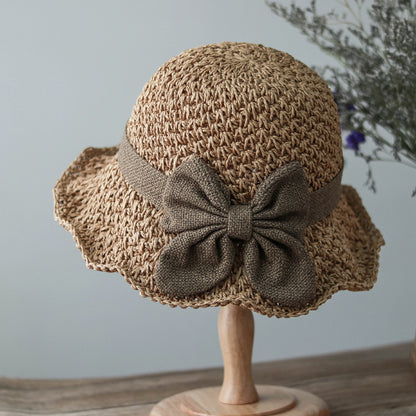 Vintage Foldable Straw Sun Hat with Wide Brim Bow in a natural color, featuring a stylish bow detail.