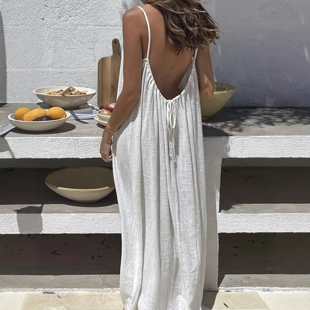 Woman wearing an Elegant Backless Maxi Evening Dress in white, showcasing the open back design at a stylish outdoor setting.
