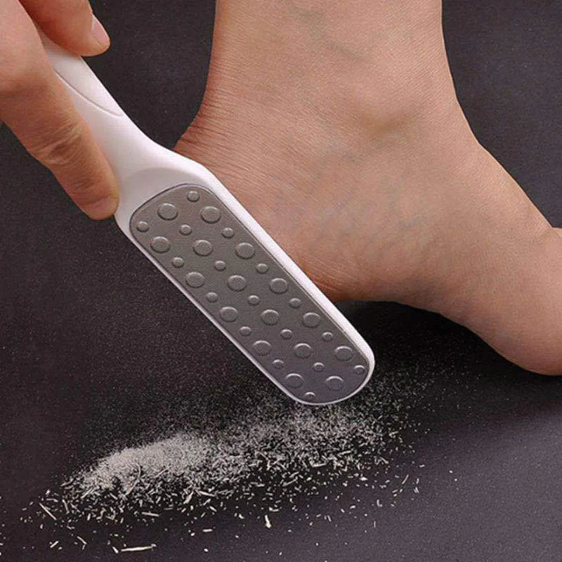 Using a Double-Sided Foot Callus Remover Tool to exfoliate dry skin on a foot.