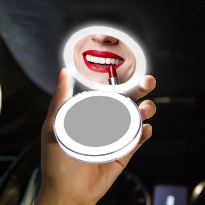 Rechargeable LED Handheld Makeup Mirror reflecting a person applying red lipstick.