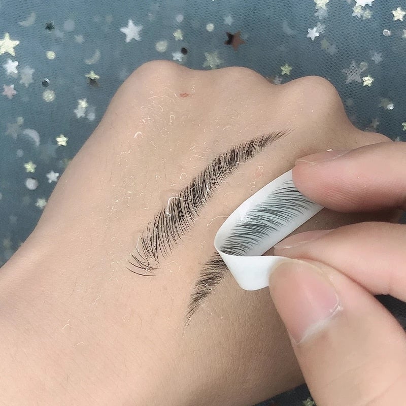 Applying 4D Waterproof Eyebrow Tattoo Stickers on skin for fuller, natural looking brows.