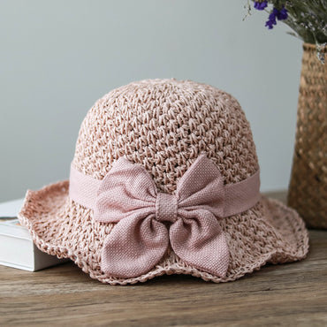 Vintage Foldable Straw Sun Hat with Wide Brim Bow in soft pink color, perfect for summer outings and casual fashion.