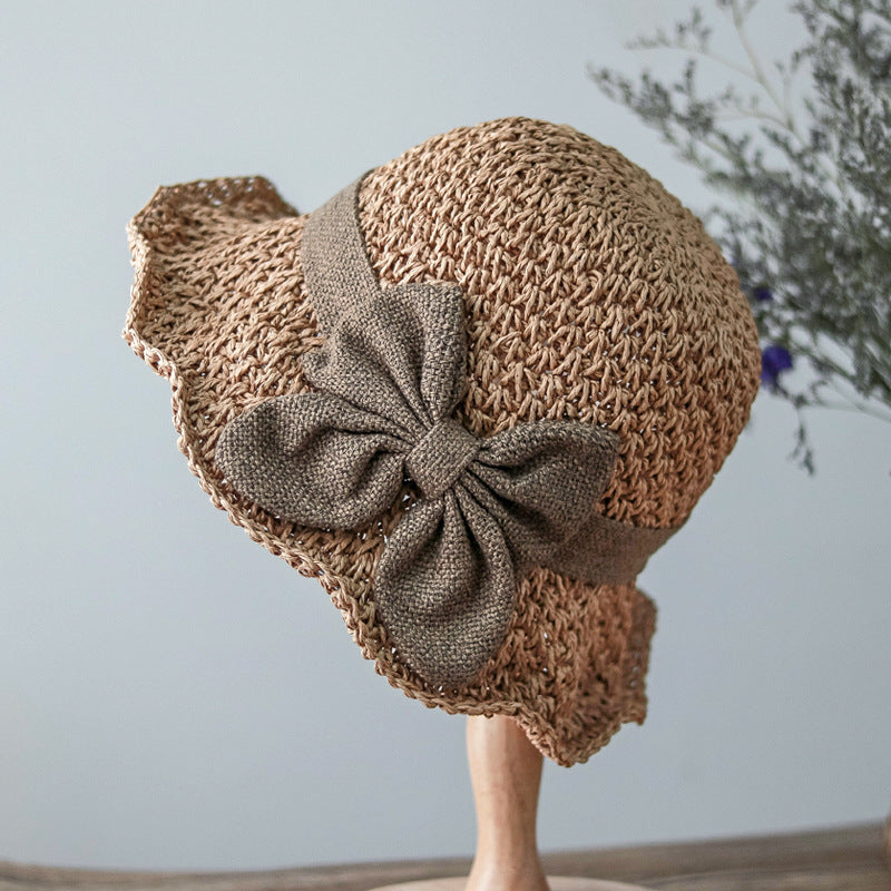 Vintage Foldable Straw Sun Hat with Wide Brim Bow featuring a stylish bow and natural straw design.