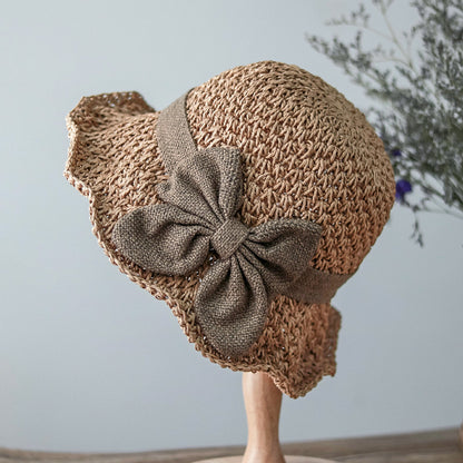 Vintage Foldable Straw Sun Hat with Wide Brim Bow featuring a stylish bow and natural straw design.