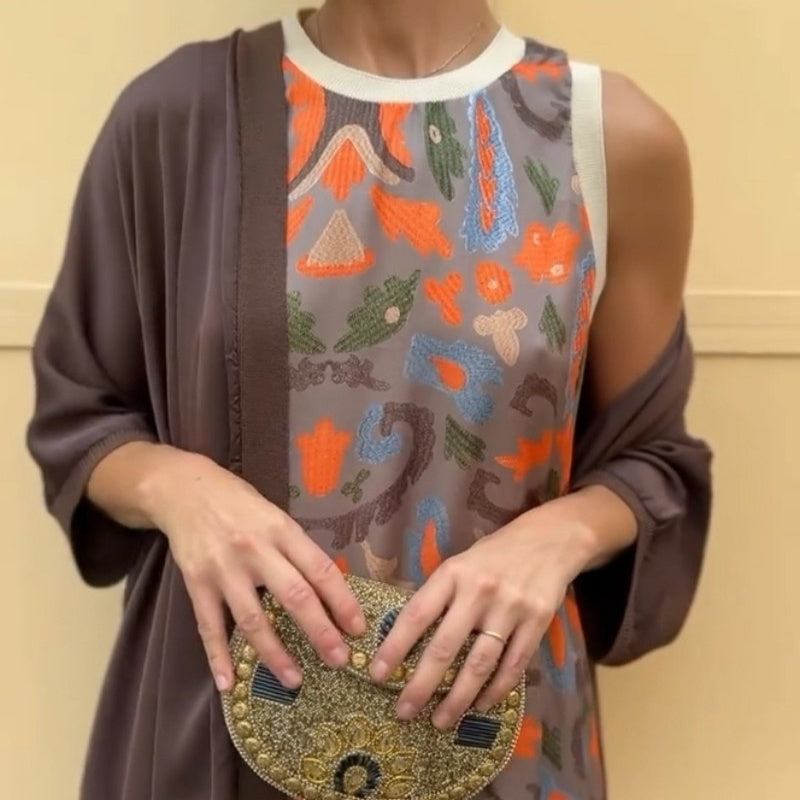 Woman modeling a Long printed dress set with matching cardigan and a stylish clutch handbag.