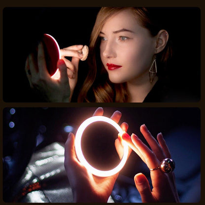 Woman applying makeup using a Rechargeable LED Handheld Makeup Mirror with bright lighting for flawless beauty.
